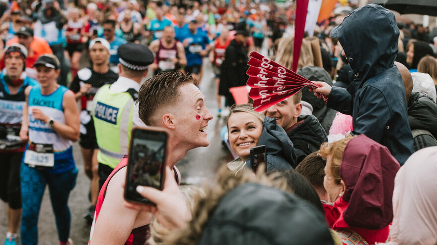 Mencap runner laughing in the crowds