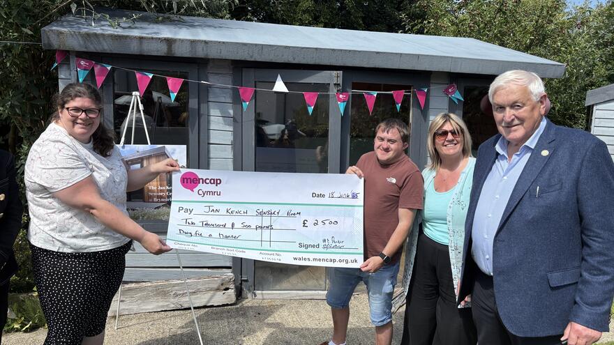 A group with a large cheque