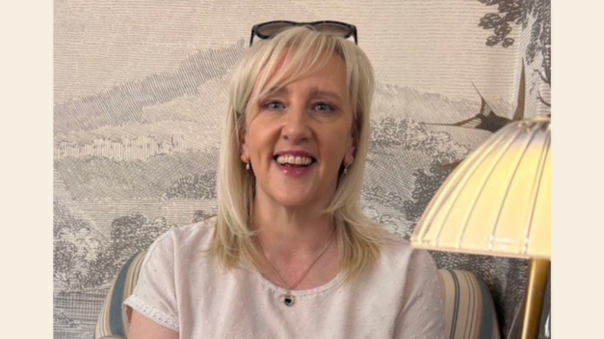 Blonde woman looking at the screen wearing sunglasses on her head